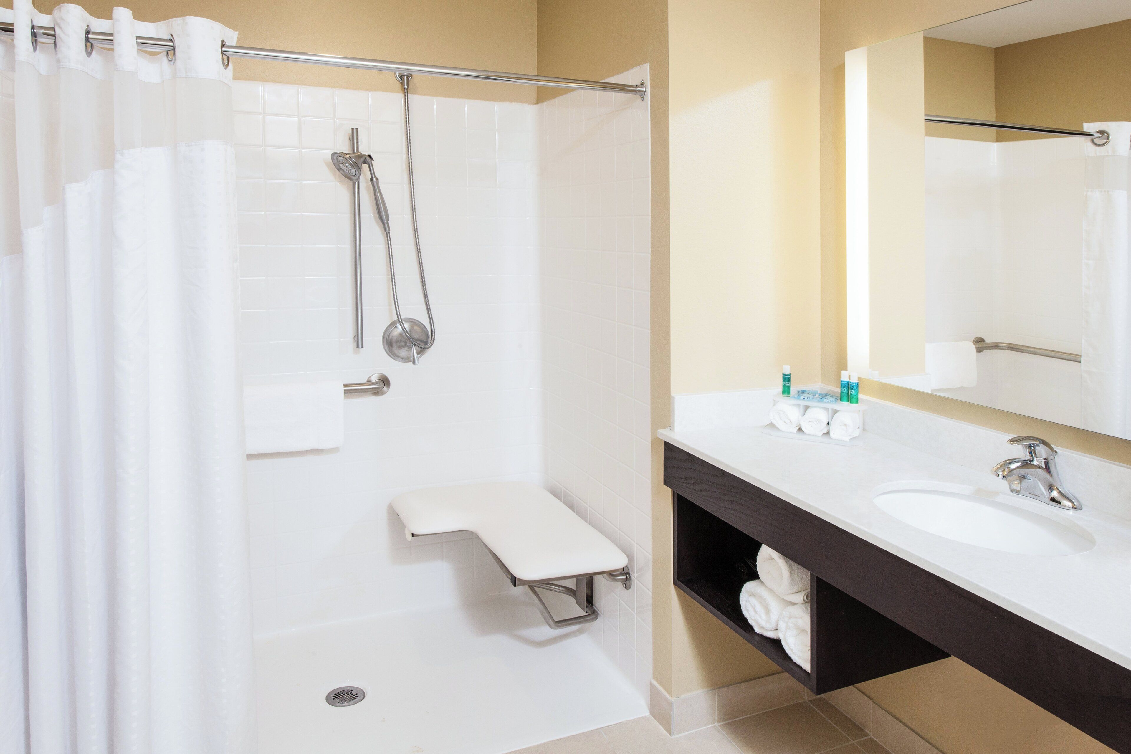 A modern bathroom with a shower, toilet, and vanity.
