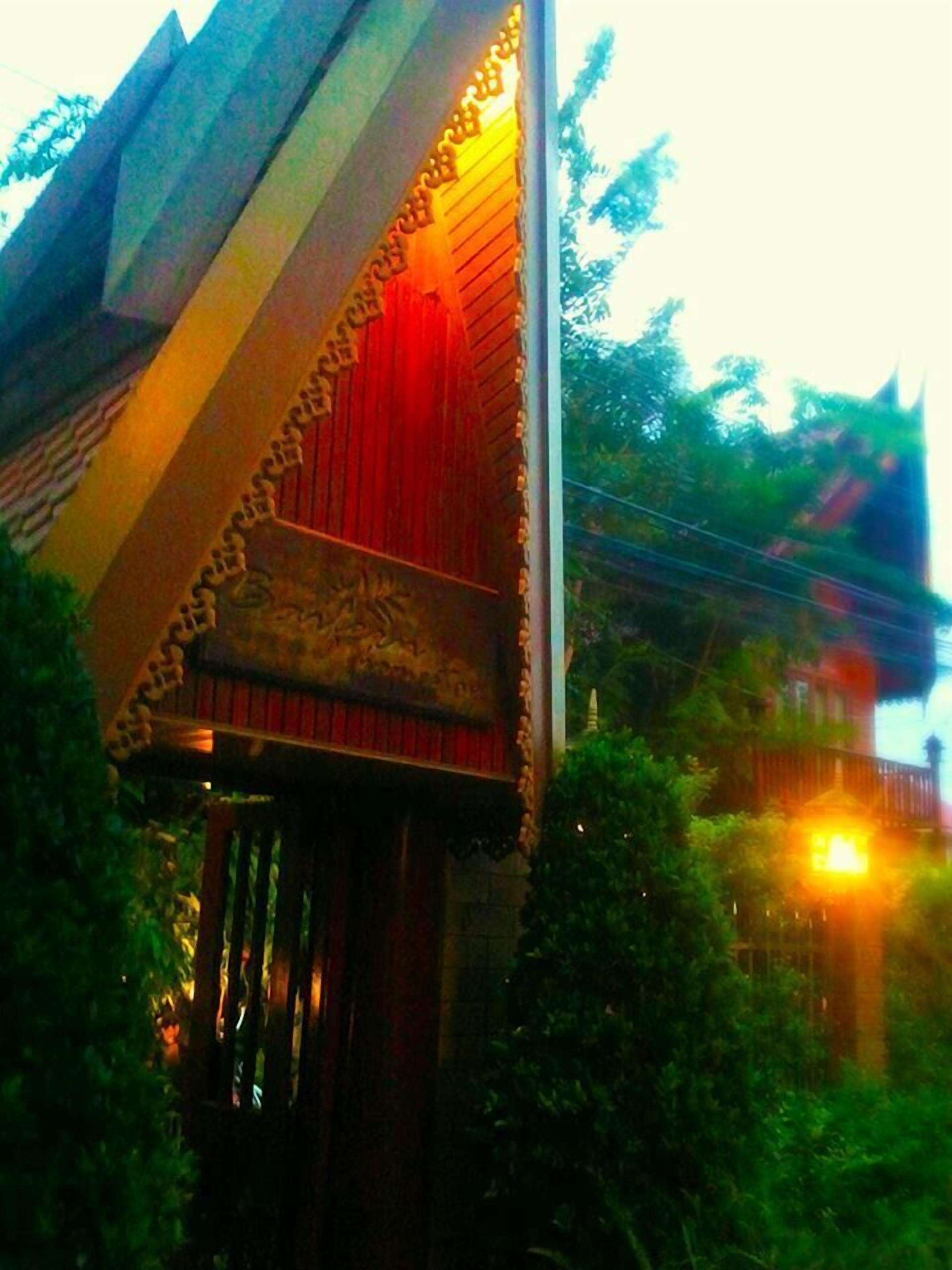 A building with a distinctive roof structure and a red curtain.