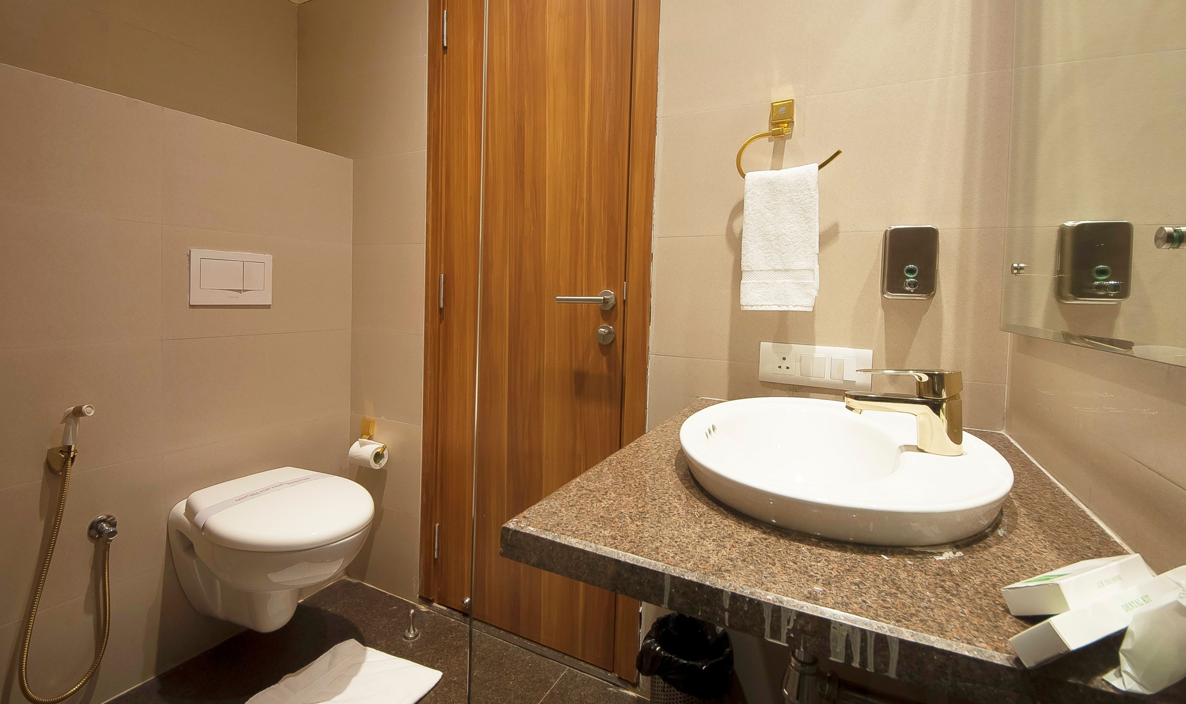 A bathroom with a toilet, sink, and shower.