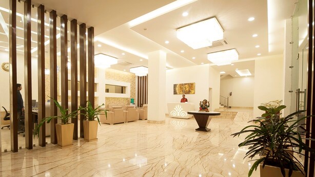 A spacious lobby with a marble floor, a reception desk, and several potted plants. - Hotel Le Roi Haridwar @ Har Ki Pauri Road (Haridwar)