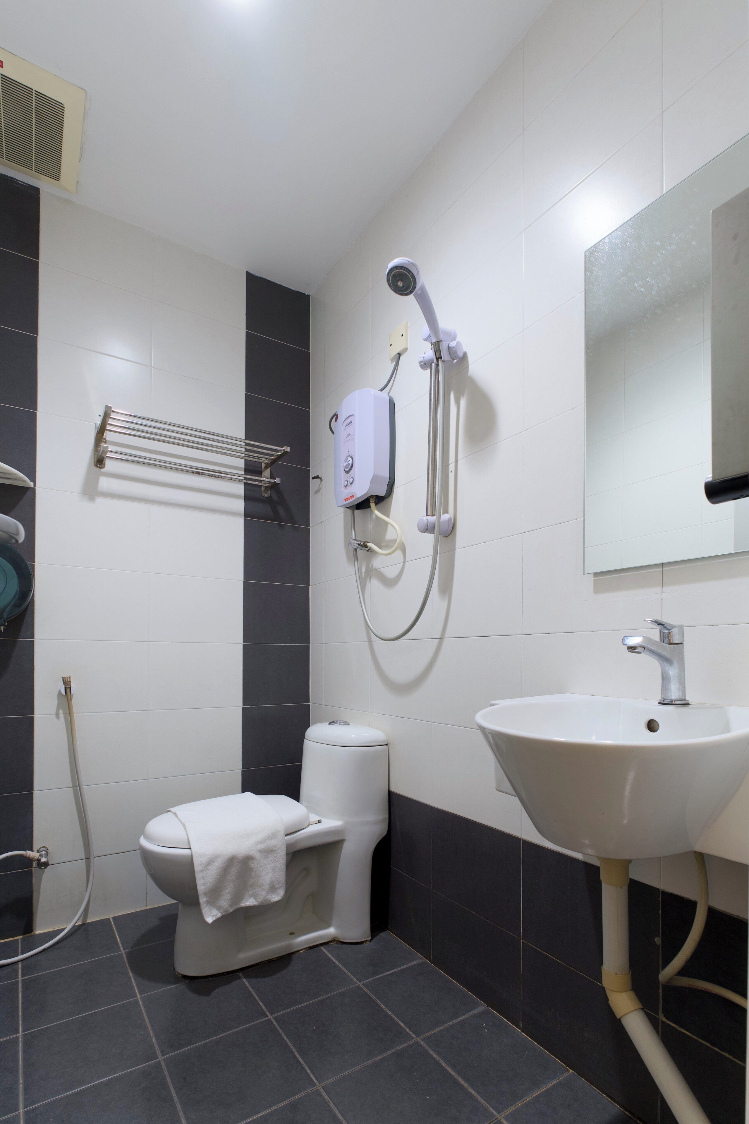 A bathroom with a toilet, a sink, and a shower.