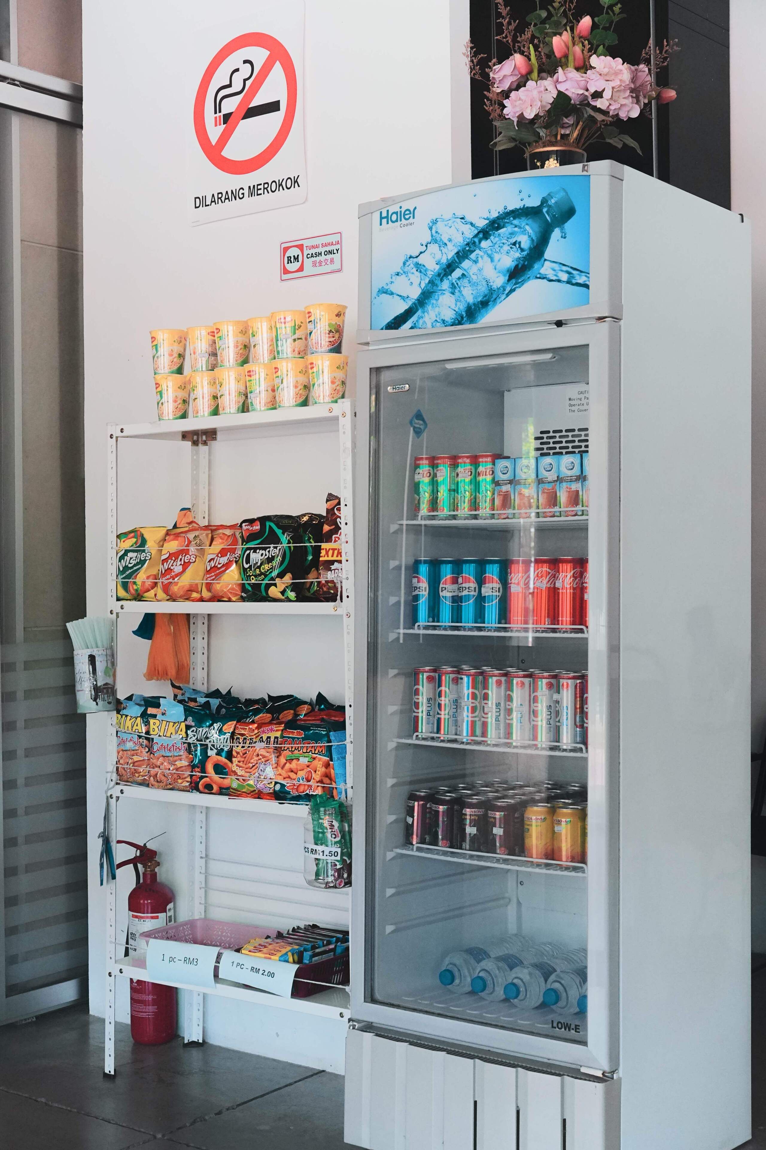A vending machine stocked with various snacks and drinks, including chips, canned beverages, and bottled water.