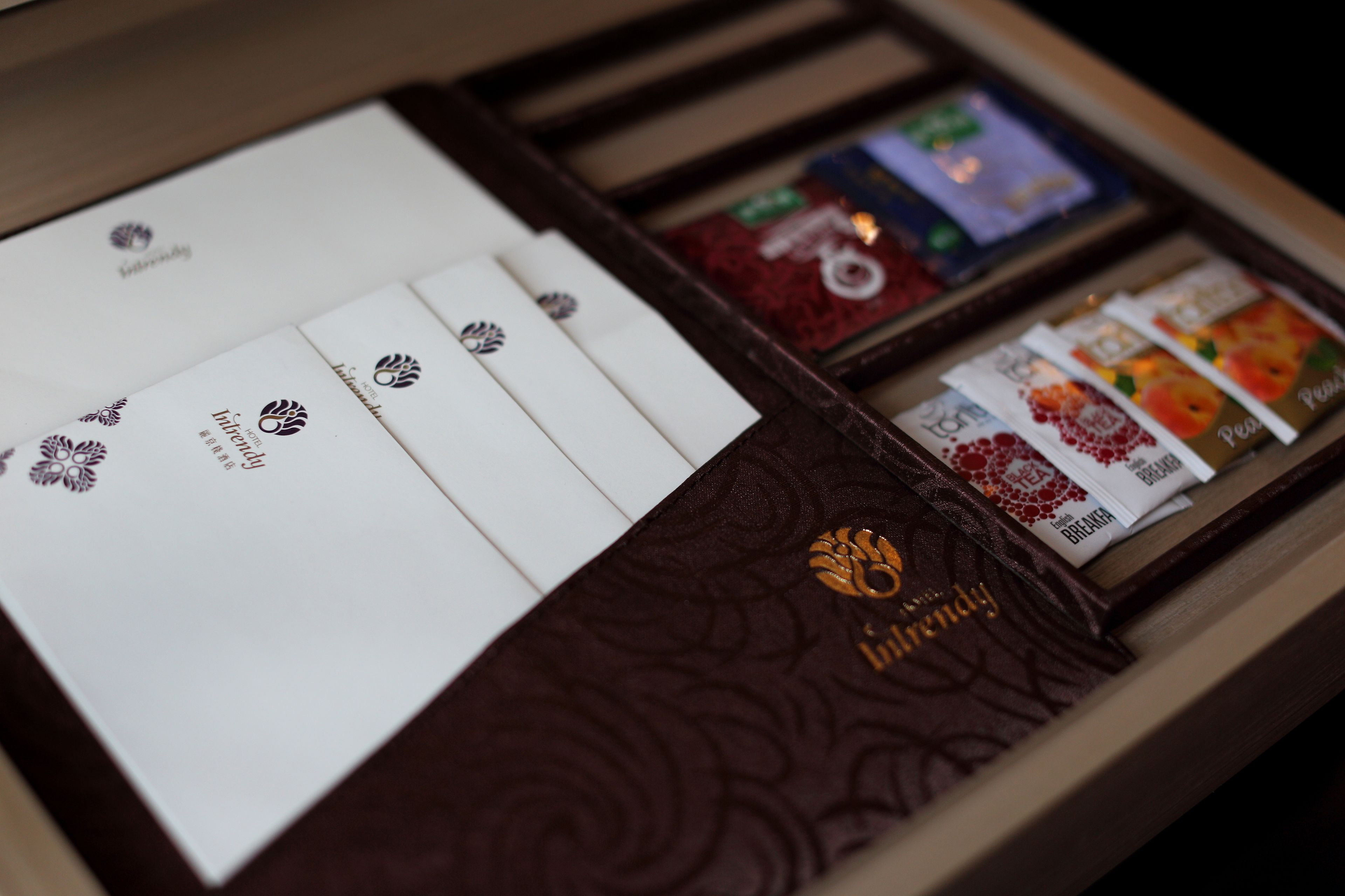 A chocolate box with a variety of chocolate bars and a booklet.