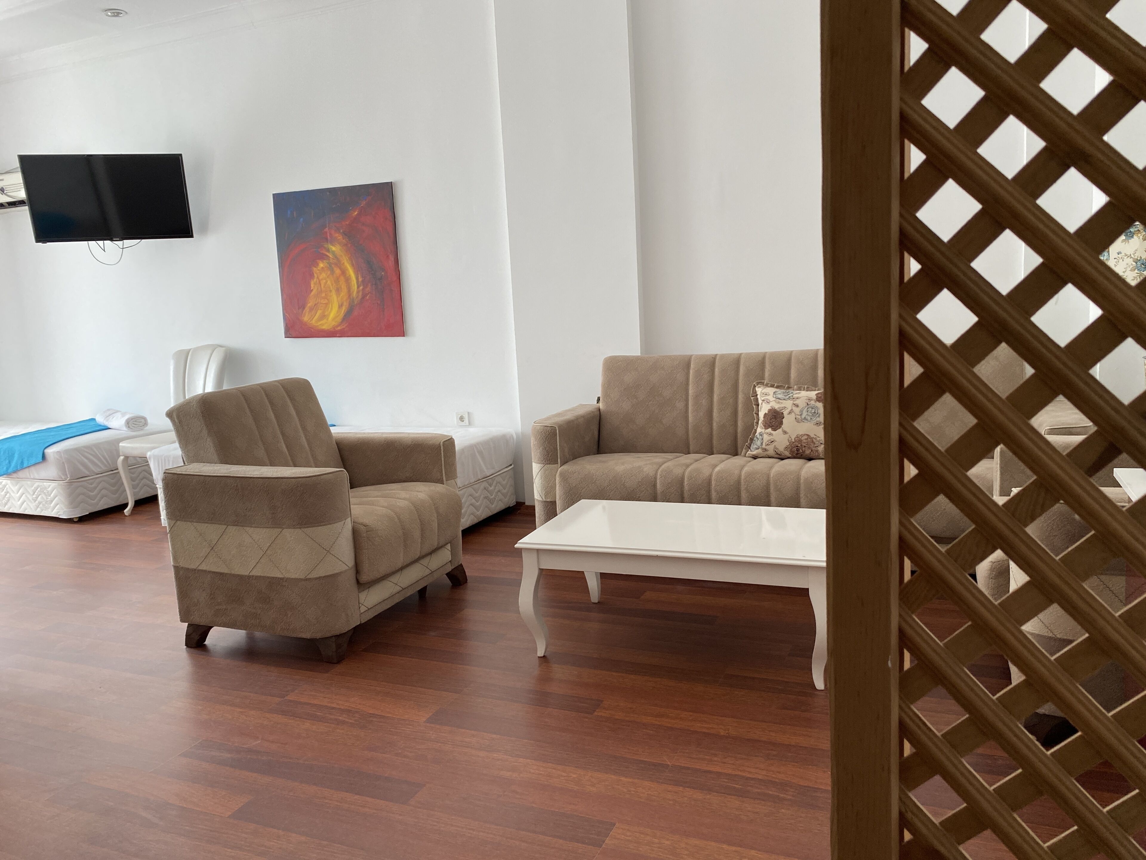 A modern living room with a sofa, armchair, and a coffee table.