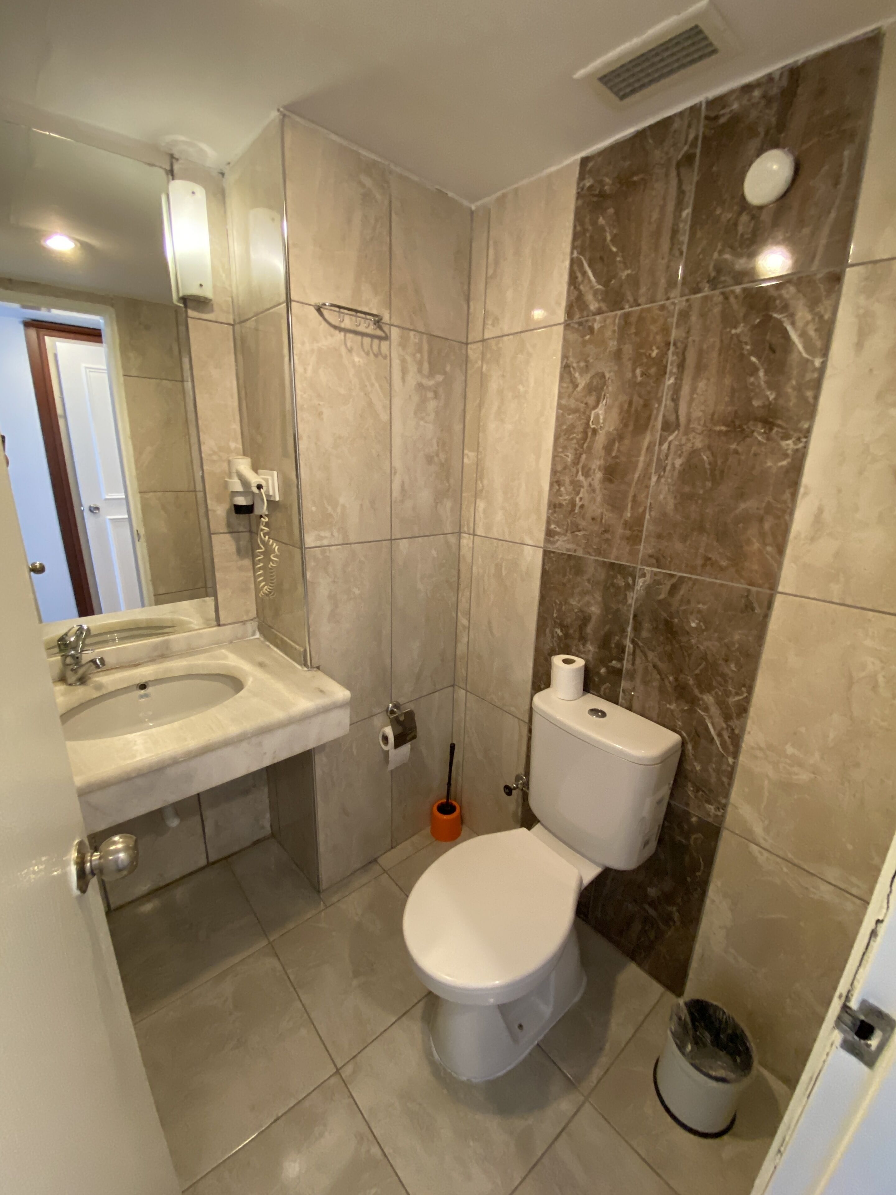 A bathroom with a sink, toilet, and shower.