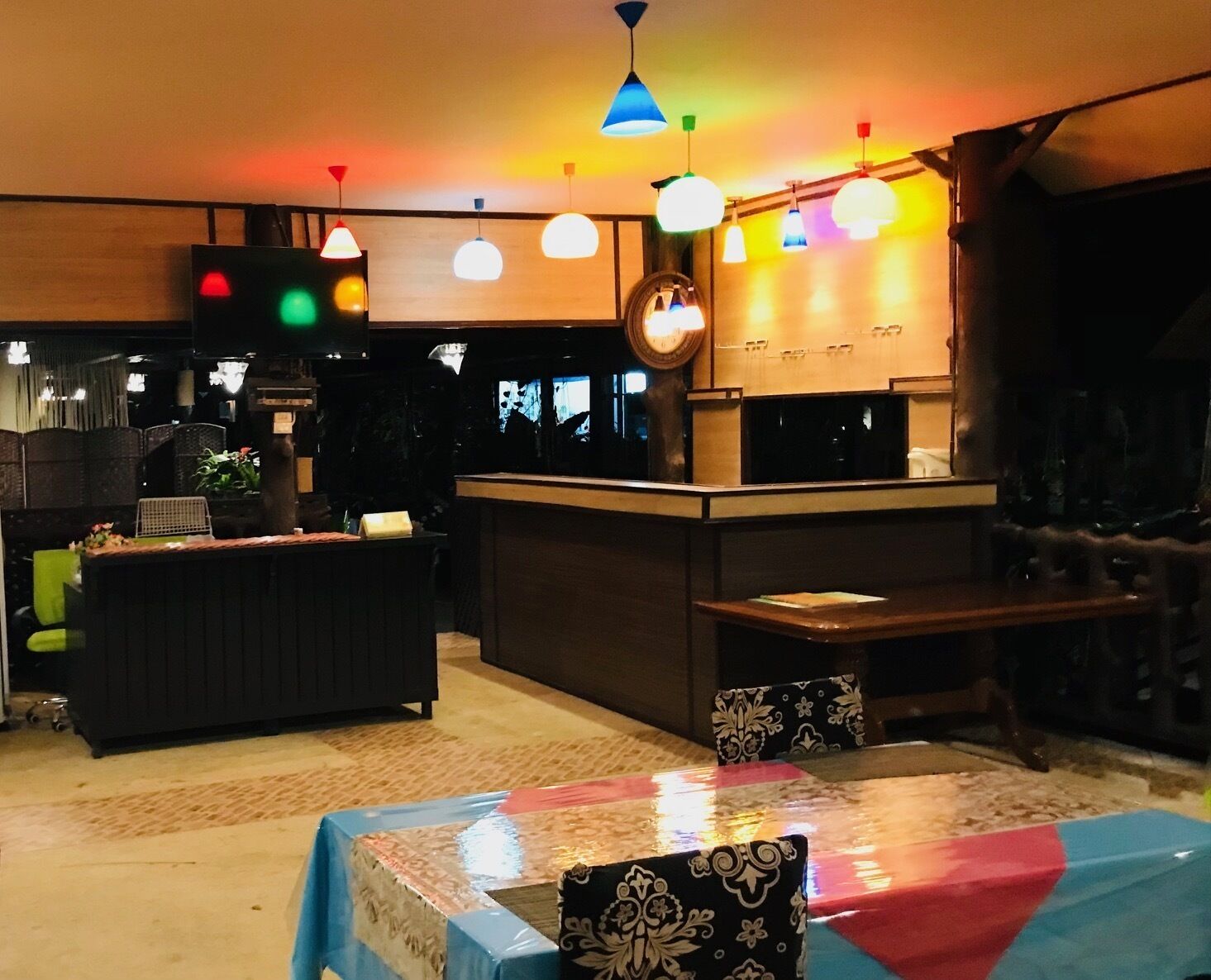 Een restaurant met een bar, zitplaatsen en een toonbank.