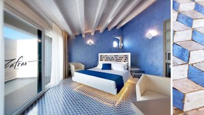 A modern hotel room with a large bed, a desk, and a view of the sea. - Zafran Boutique Hotel (Scicli)