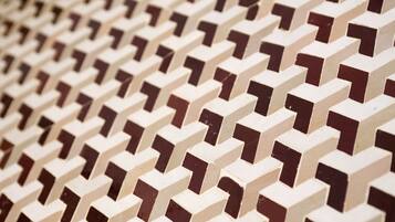A close-up of a patterned wall with a repeating geometric design.