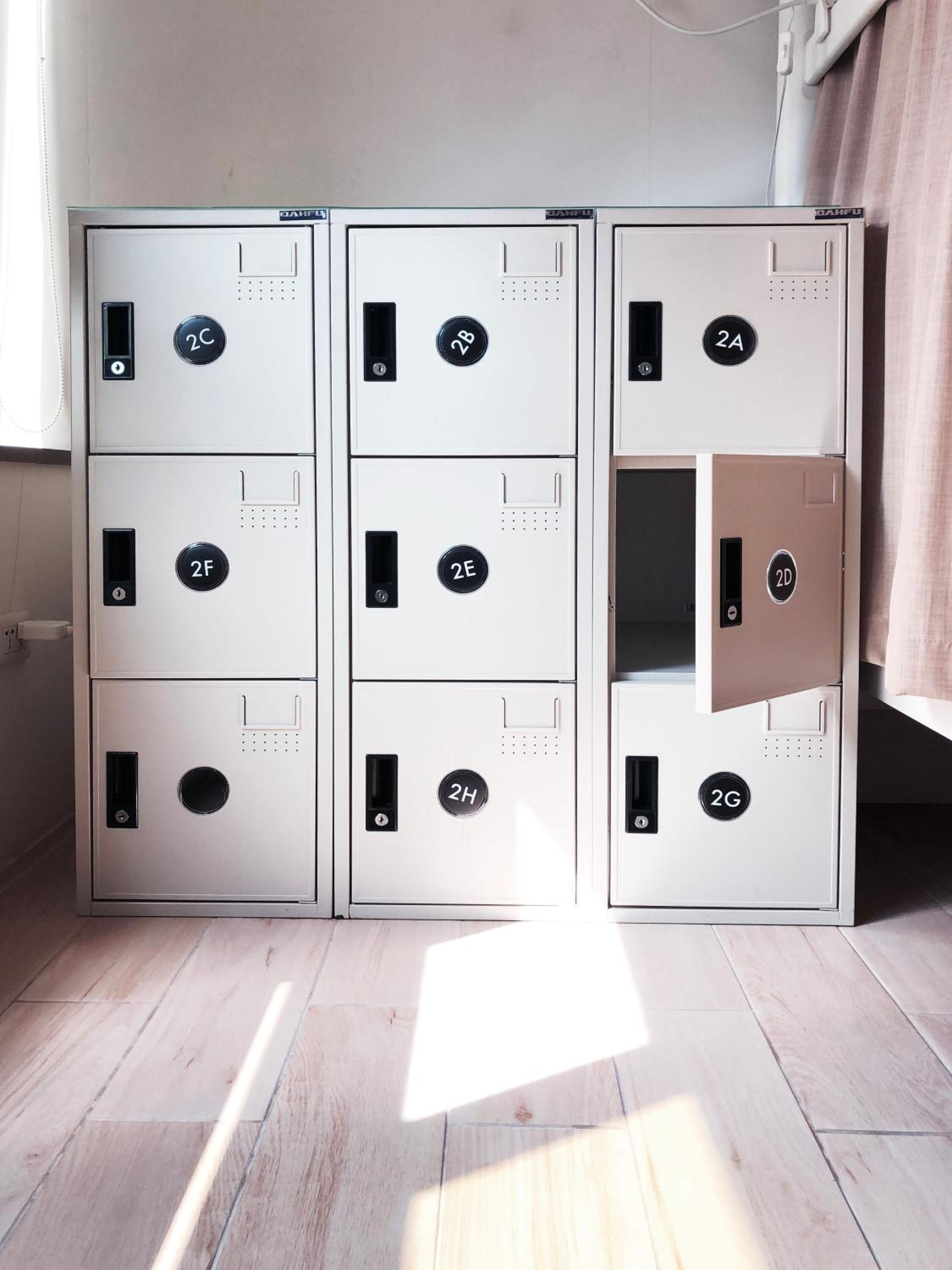 A set of six metal safes with numbered locks, arranged in two columns.