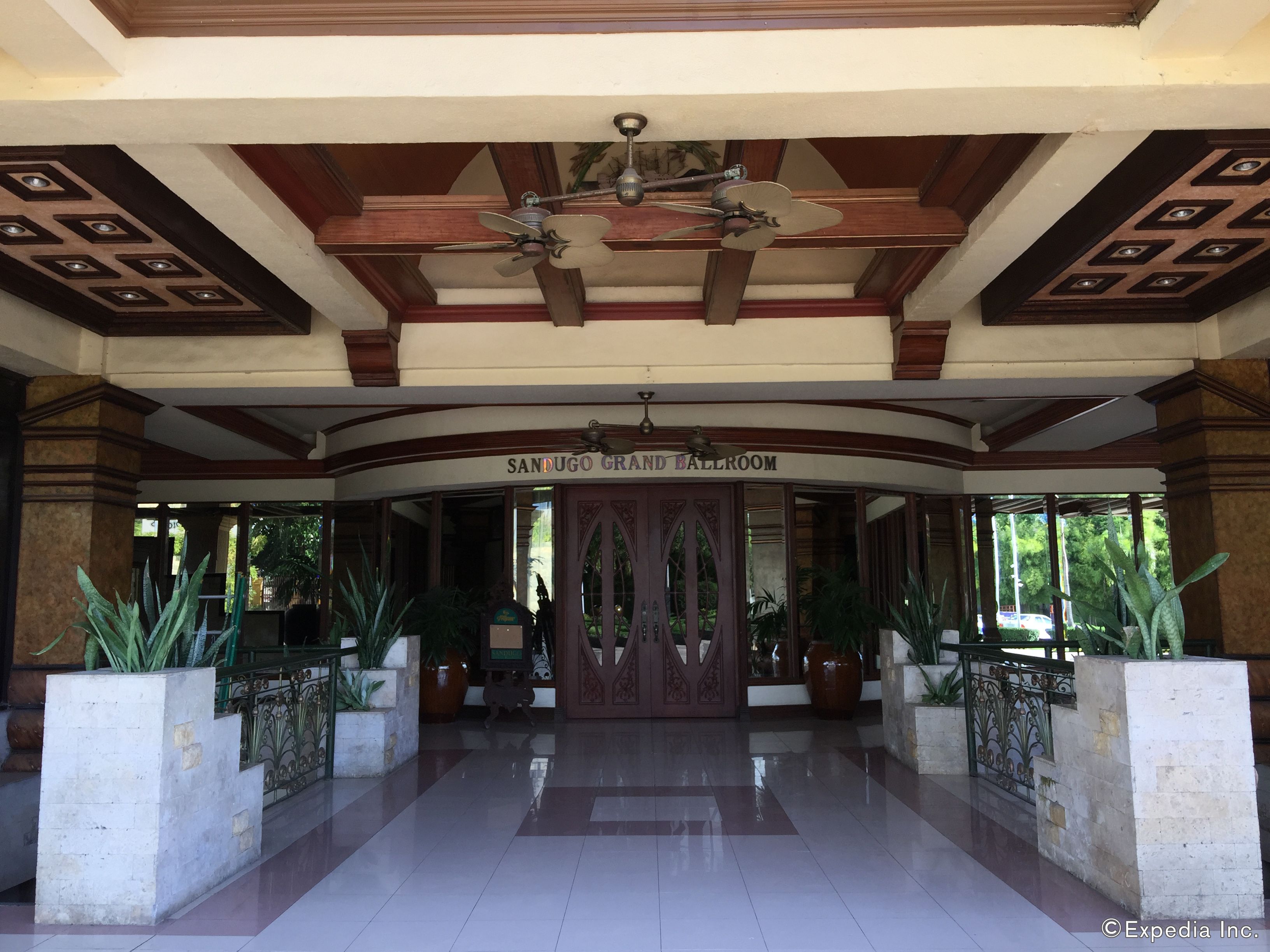 A grand entrance with a ceiling fan, a sign reading "SANDUGO GRAND BALLROOM", and a tiled floor.