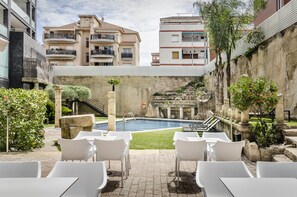 Indoor pool, seasonal outdoor pool, pool umbrellas, pool loungers