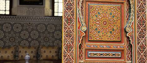 A richly decorated door with intricate patterns and a metal latch.