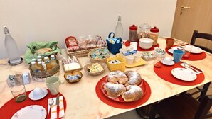 A dining table set with various food items, utensils, and containers. - Casa Mariella (Naples)