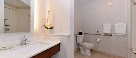 A bathroom with a sink, toilet, and shower.