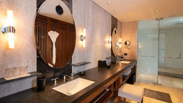 A modern bathroom with a long vanity, two sinks, and a large mirror.