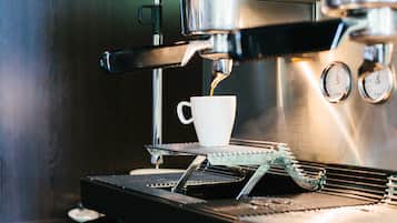 A coffee machine dispensing coffee into a cup.