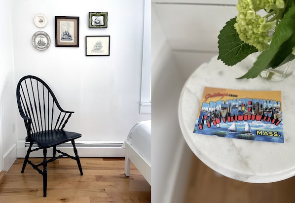 A room with a black chair, a bed, and wall-mounted artwork. - Salt House Inn (Provincetown)