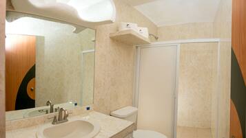 A bathroom with a sink, toilet, and shower.