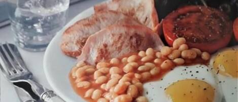 A plate of food with eggs, beans, and toast.