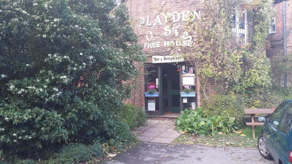 A brick building with a sign reading 'PLAYDON O ST FREE HOUSE'.