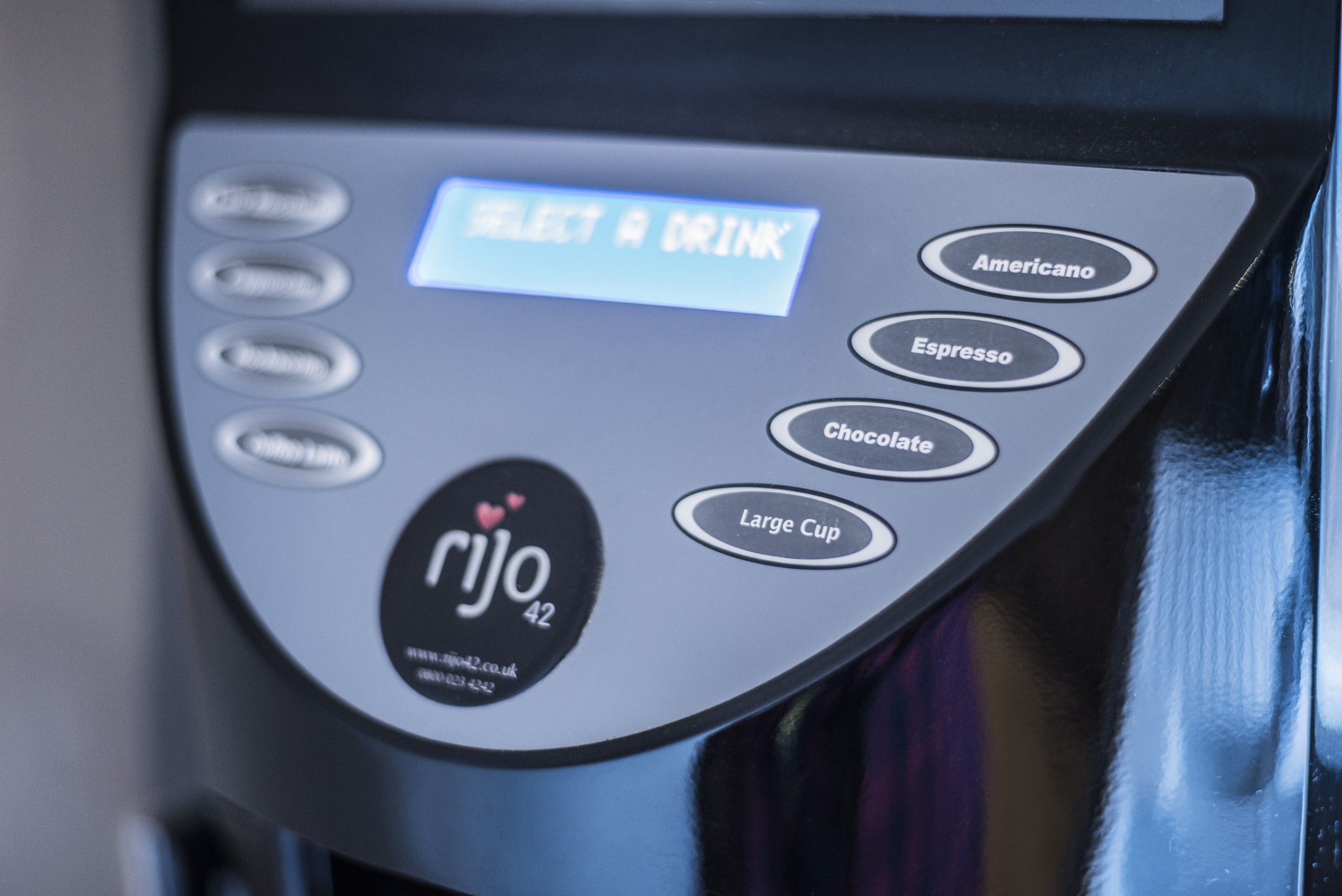A coffee machine with options for Americano, Espresso, Chocolate, and Large Cup.