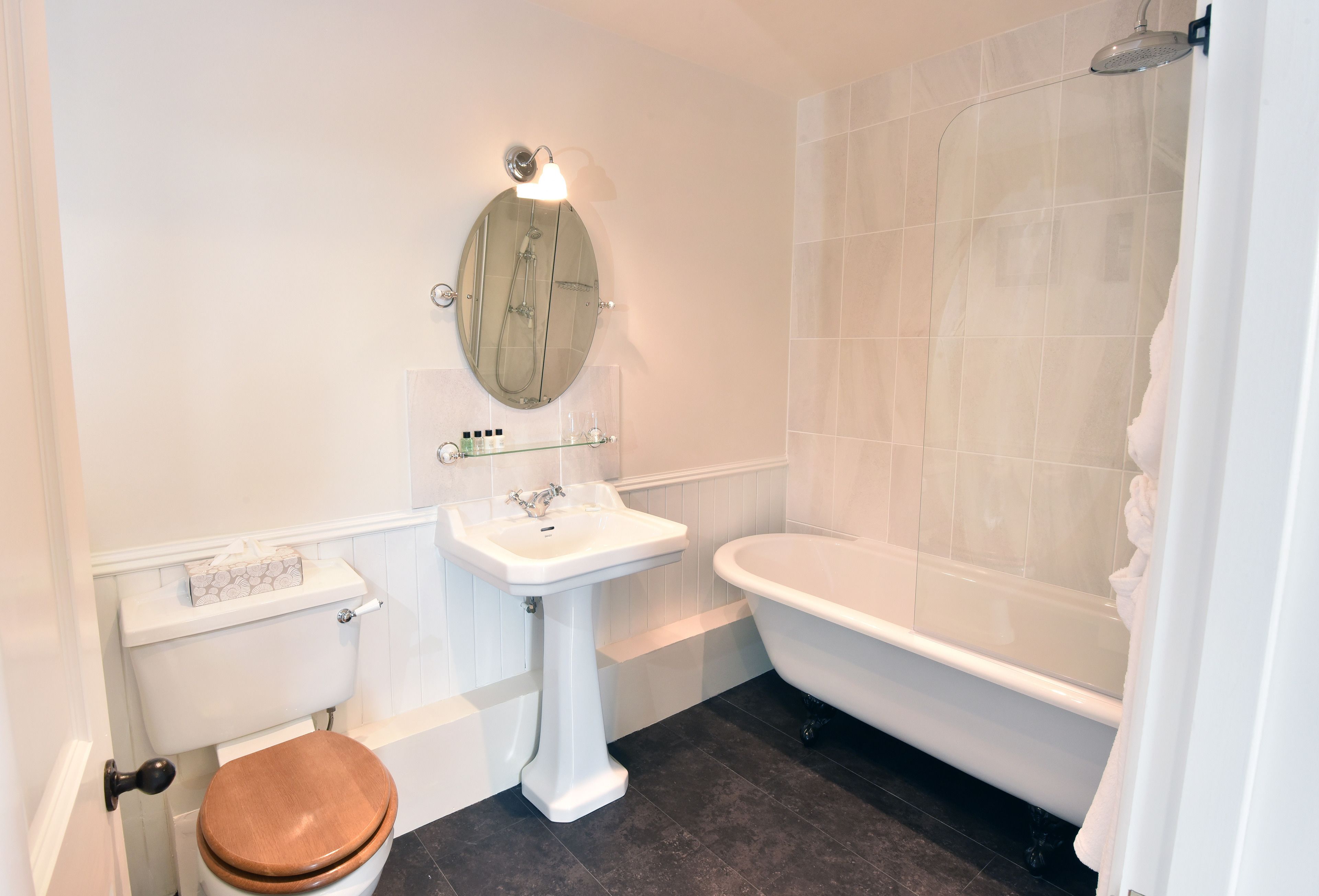 A bathroom with a toilet, sink, and bathtub.