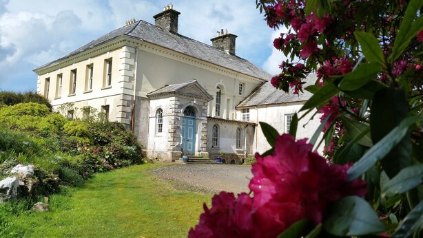 A large, historic building with a prominent entrance and a well-maintained garden. - Kelly House (Lifton)