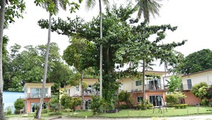 A hotel with multiple two-story buildings, surrounded by lush greenery and palm trees. - Z-Touch Lipe Island Resort (Koh Lipe)
