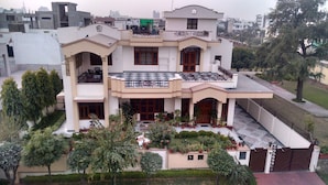 A multi-story residential building with balconies, a gated entrance, and a well-maintained garden. - Jaipur Friendly Villa (Jaipur)
