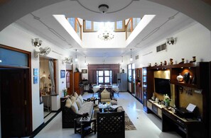 A spacious living room with a high ceiling, a dining area, and a kitchen. - Jaipur Friendly Villa (Jaipur)
