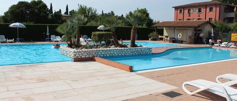 Outdoor pool, open 7:00 AM to 9:00 PM, pool umbrellas, sun loungers