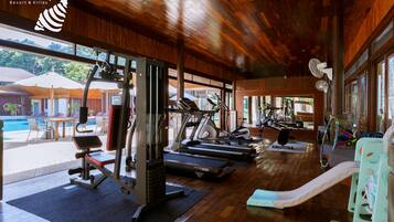 A gym with treadmills, weight machines, and a slide.