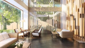 A modern interior with a sofa, two armchairs, a coffee table, and a decorative wall with vertical panels.