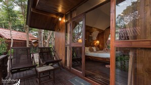 A wooden deck with two wooden chairs and a welcome mat. - Bundhaya Resort Koh Lipe (Koh Lipe)