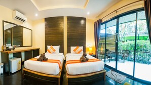 A hotel room with two beds, a large window, a mirror, a desk, and a trash bin. - Leelawadee Lipe Resort (Koh Lipe)