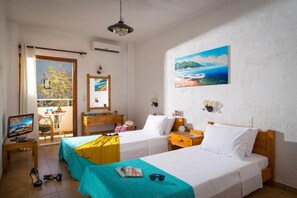 A hotel room with two beds, a TV, a balcony with a view, and a painting on the wall. - Floral Hotel (Hersonissos)