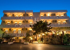 A multi-story hotel with balconies, a central entrance, and outdoor seating areas. - Floral Hotel (Hersonissos)