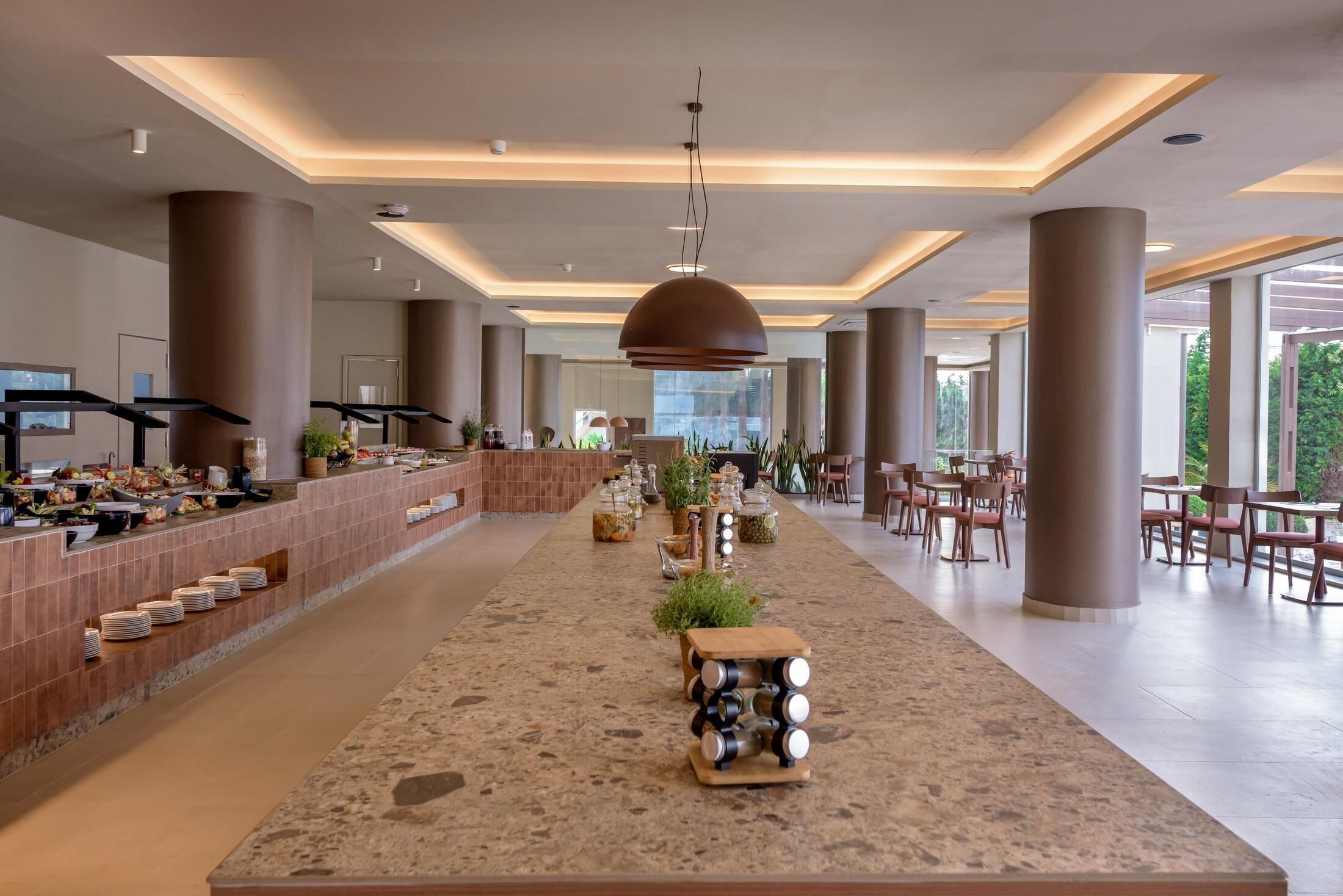 A spacious lobby with a long counter, multiple seating areas, and large windows.