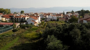 A coastal village with traditional Mediterranean-style buildings, a clear view of the sea, and a hilly landscape. - Kavos Panorama Complex (Corfu)
