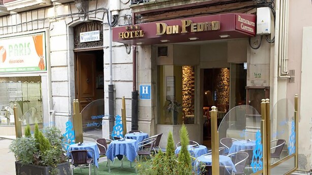 A hotel exterior with outdoor seating, a sign reading "Don Pedro Hotel," and a visible entrance. - Don Pedro (Aviles)