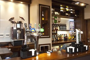 A bar area with multiple taps, a coffee machine, and a well-stocked liquor shelf. - Premier Inn London Hanger Lane (London)