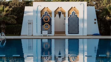 Outdoor pool, open 9:00 AM to 9:00 PM, pool umbrellas, pool loungers