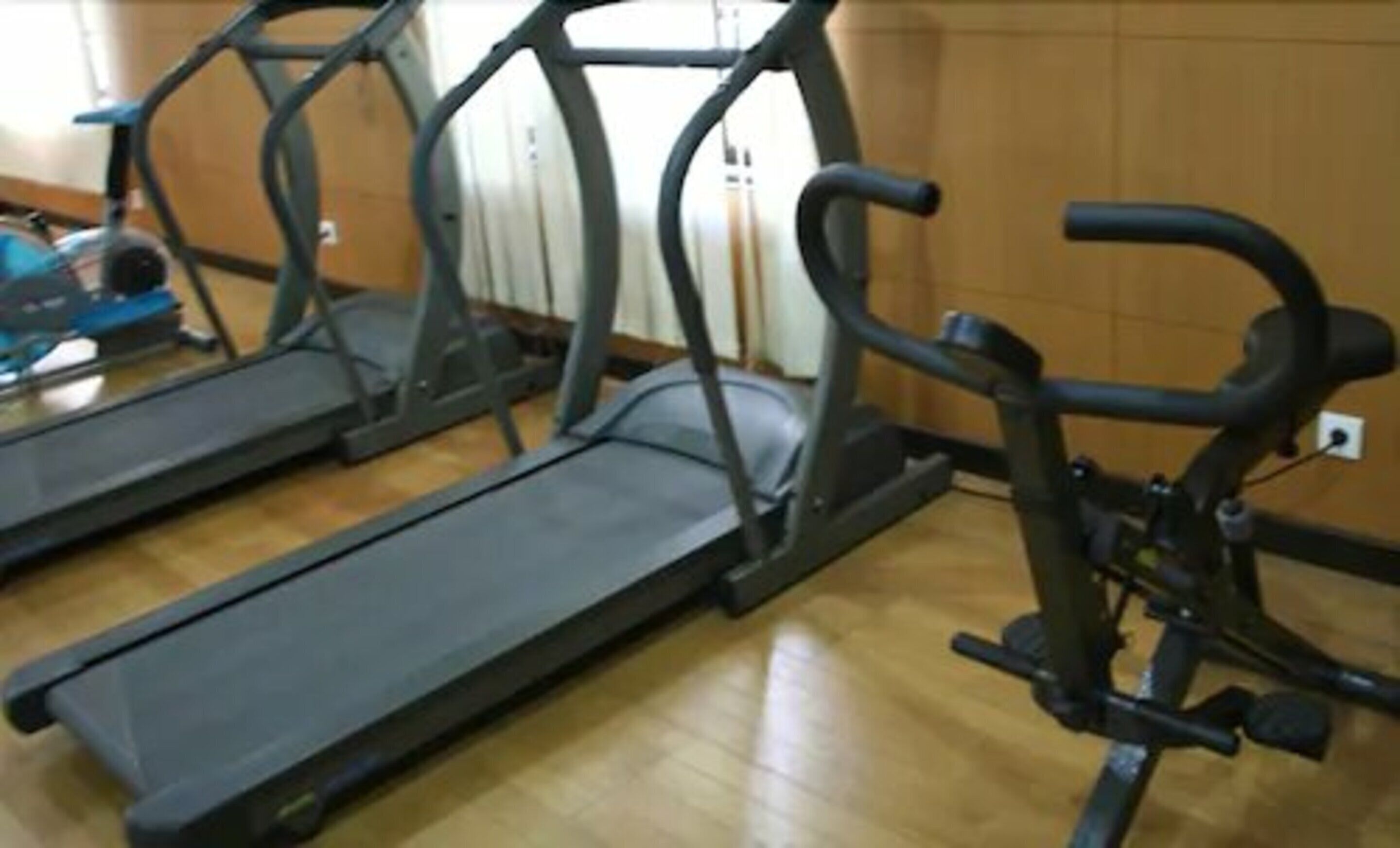 A gym with treadmills and weight machines.