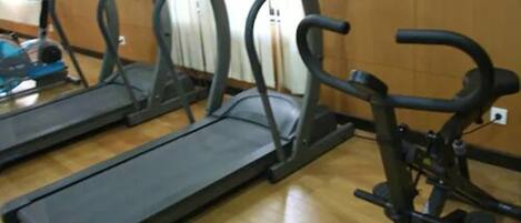 A gym with treadmills and weight machines.