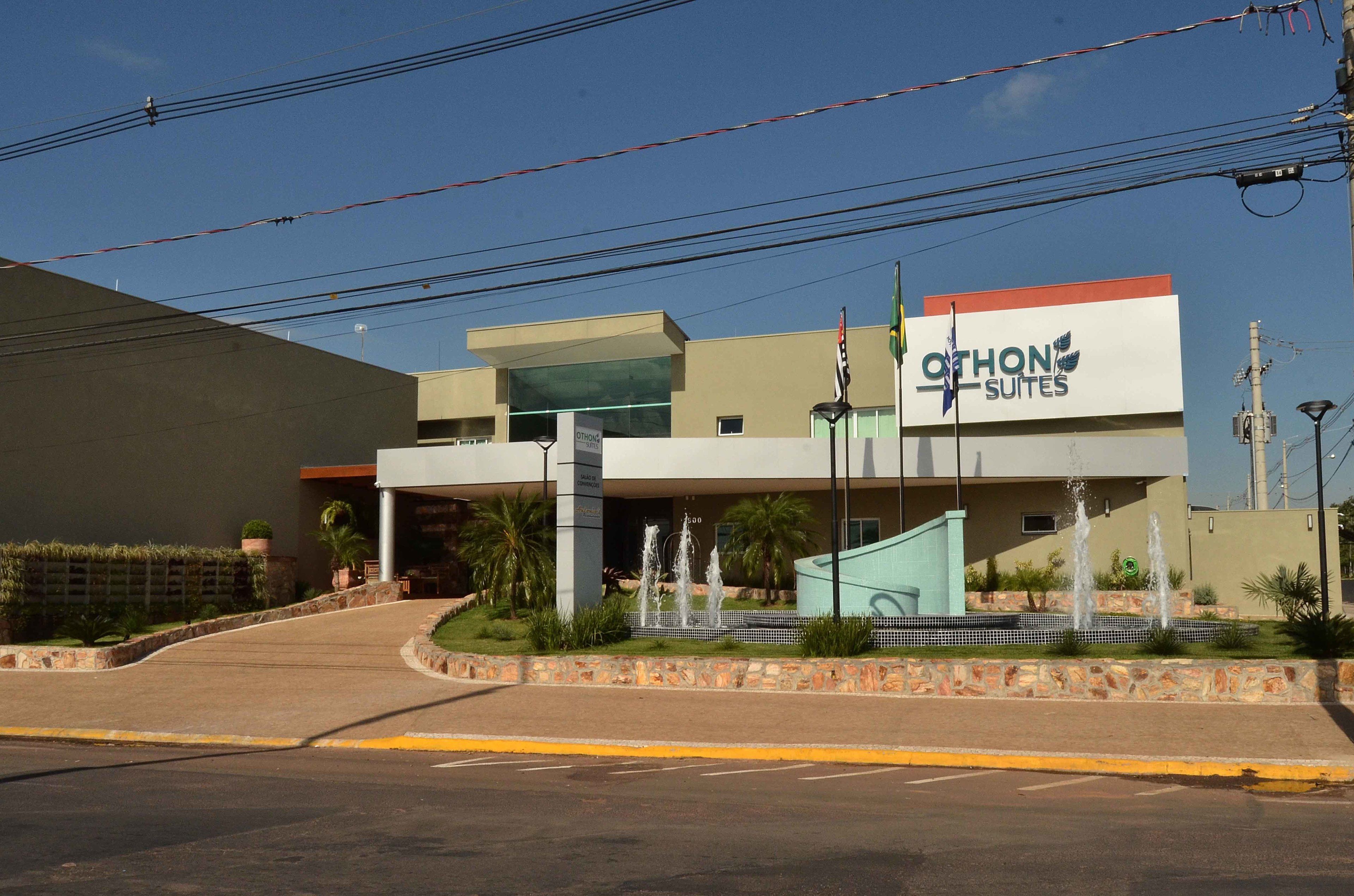 A hotel with a modern design, featuring a prominent sign for 'Othon Suites'.