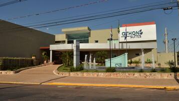 A hotel with a modern design, featuring a prominent sign for 'Othon Suites'.
