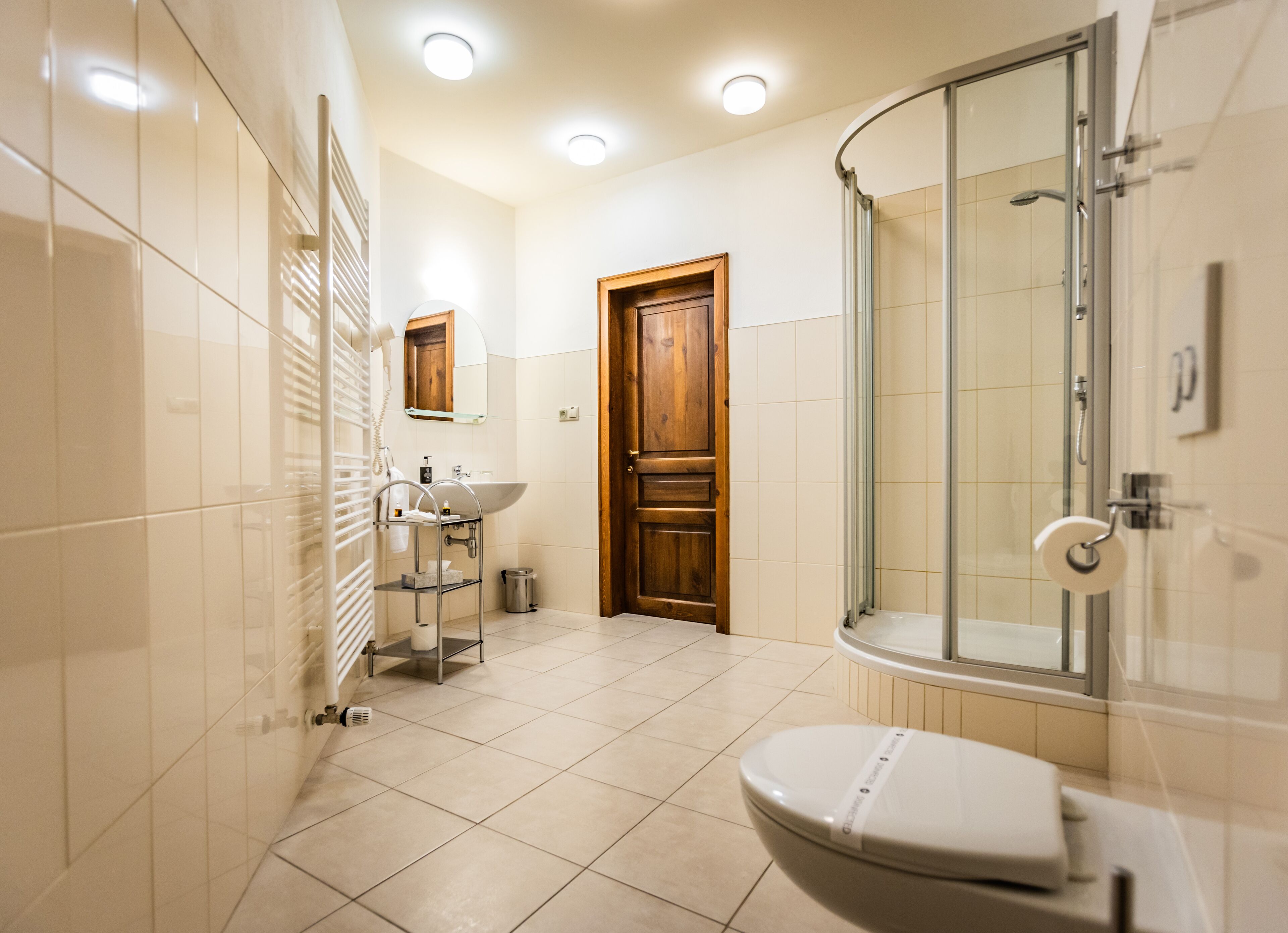 A modern bathroom with a toilet, sink, and shower.