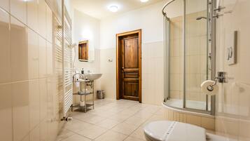 A modern bathroom with a toilet, sink, and shower.
