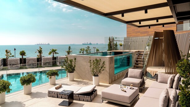 A rooftop pool area with lounge chairs, a hot tub, and a view of the sea. - Crowne Plaza Istanbul Florya by IHG (Istanbul)
