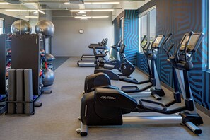 A gym with treadmills, elliptical machines, and exercise balls. - Aloft by Marriott Santa Clara (San Jose)